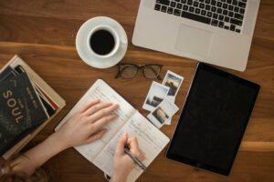 Journaling at a desk with coffee