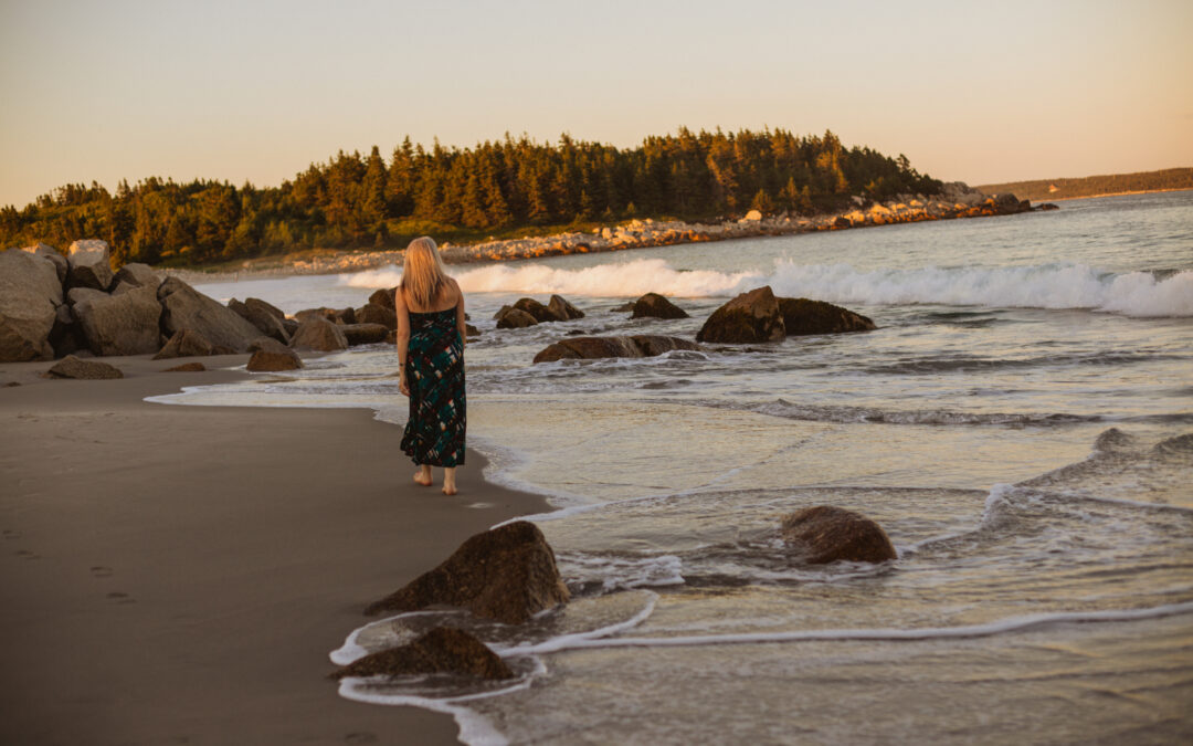 Woman on beach practicing mindfulness.