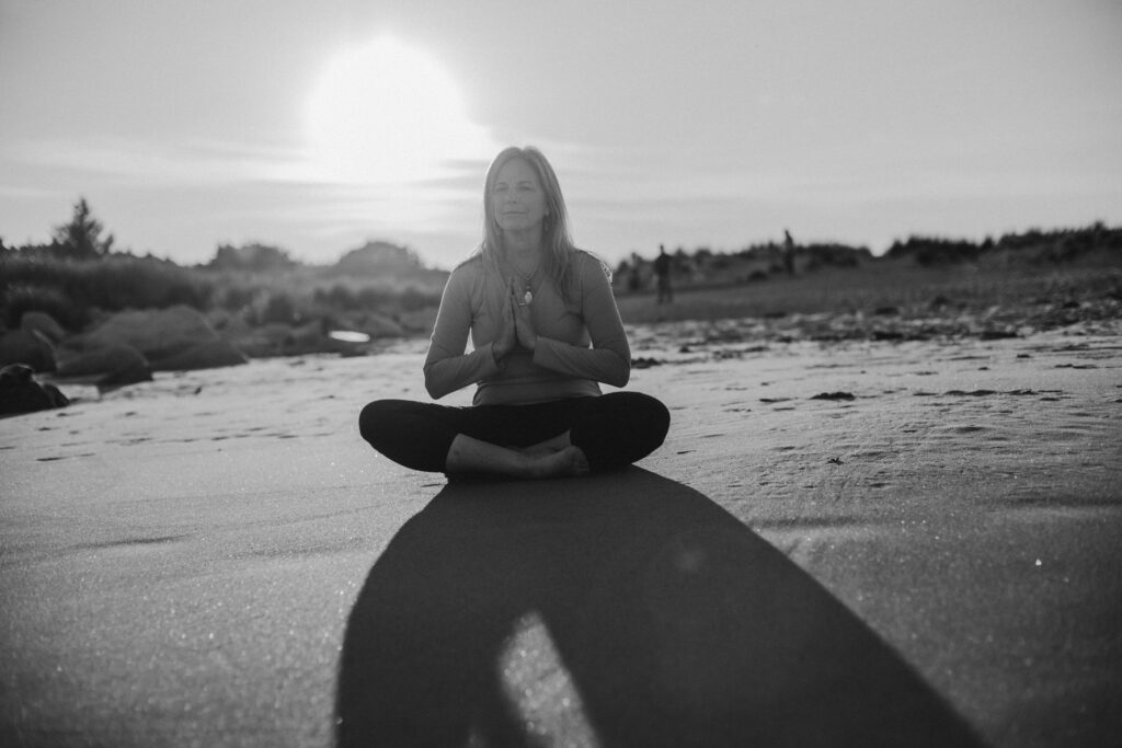 Meditation and breathing on the beach to reduce stress.